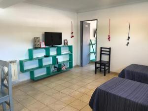 a room with two beds and a television on a shelf at Departamento Belgrano 7 in Salta