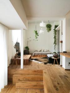 a living room with wood floors and a bed at Loft del Talvera 1 in Bolzano