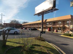 a sign in a parking lot in front of a building at Augusta Best Inn in Augusta