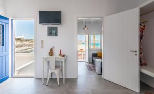 a room with a table and a view of the ocean at Manolis And Filio Home -By The Sea in Pachaina