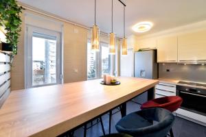 a kitchen with a large wooden table and two chairs at First Choice Ilica - Spacious 3-Bedroom Apartment with Parking in Zagreb