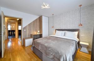 a bedroom with a large bed and a dining room at First Choice Ilica - Spacious 3-Bedroom Apartment with Parking in Zagreb