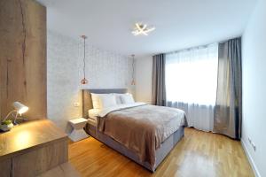 a bedroom with a bed and a large window at First Choice Ilica - Spacious 3-Bedroom Apartment with Parking in Zagreb