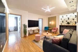 a living room with a couch and a flat screen tv at First Choice Ilica - Spacious 3-Bedroom Apartment with Parking in Zagreb