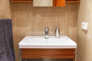a white sink in a small bathroom with at Apartamentos El Llombo in Ontinyent +20 photos