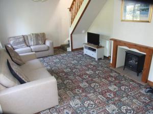 a living room with a couch and a fireplace at firtrees in Selby