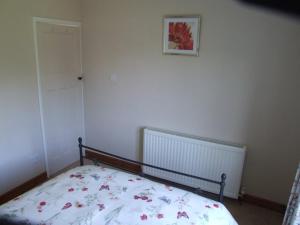 a bedroom with a bed with a floral bedspread at firtrees in Selby