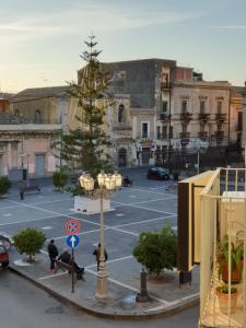 a christmas tree in the middle of a parking lot at Duomo Rooms b&b in Lentini