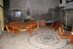 a patio with wooden tables and chairs in a room at maison d en haut in Wintzenheim