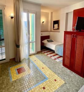 a bedroom with a bed and a television in a room at Hotel Della Baia in Portovenere