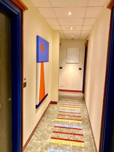 a hallway with a colorful tile floor in a building at Hotel Della Baia in Portovenere