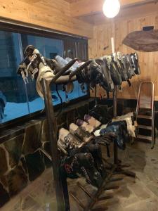 a bunch of shoes on a rack in a room at Hotel Patriot in Mestia