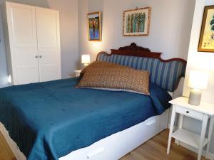 a bedroom with a bed with a blue comforter at Villa Mia in Vence