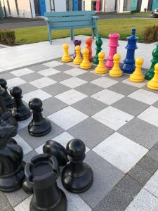 a chess board with colorful chess pieces on it at 6 Hatheran Square in Portstewart
