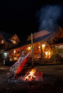 a fire in front of a building at night at Hosteria Sudbruck in San Carlos de Bariloche