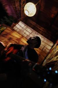 a man looking up at a light in a room at Tetebatu Flush Harmony in Tetebatu +143 photos