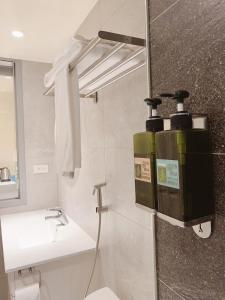 a bathroom with a toilet and a sink at 日出逢甲 in Taichung