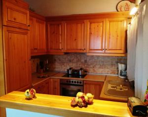 a kitchen with wooden cabinets and a counter top at Villa Amfithea in Skiathos +13 photos