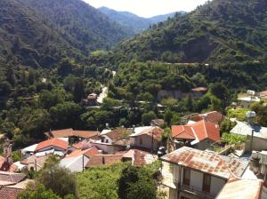 a town in a valley with mountains in the background at Maison Elena in Kalopanayiotis