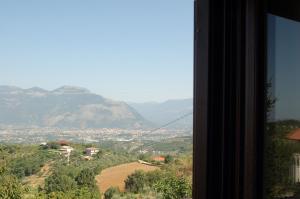 a view of a valley from a window at La Staccionata in Arpino
