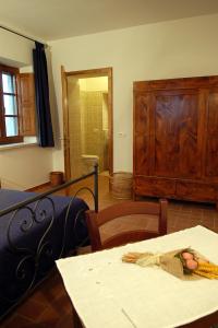 a bedroom with a bed and a desk at Poderone Vecchio in Sorano