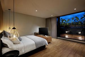 a bedroom with a bed and a large window at 14 Urban Hotel in Medellín