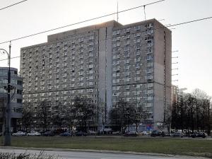 un grand bâtiment avec des voitures garées devant lui dans l'établissement Apartment Saski Garden Marszalkowska street, à Varsovie