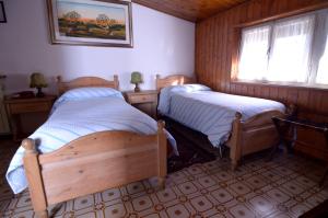 a bedroom with two beds and a window at Albergo Mirella in Belluno