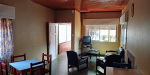 a dining room with a table and chairs and a television at Lavalle hostel in Posadas
