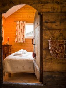 a bedroom with a bed in a wooden room at Le Bivouac in Chamonix