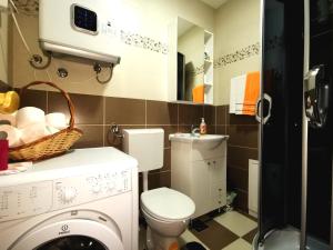 a bathroom with a toilet and a washing machine at Apartments Center Sarajevo in Sarajevo