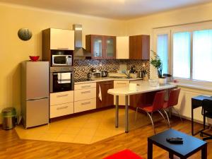 a kitchen with a refrigerator and a table at Peaceful Place in Old Town in Bratislava