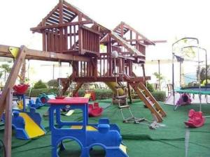 a playground with a tree house on top of it at شاليهات بورتو ساوث بيتش للأسر فقط An in Ain Sokhna