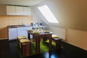 a kitchen with a table with chairs and a sink at Monte Kali in Mittelkalbach