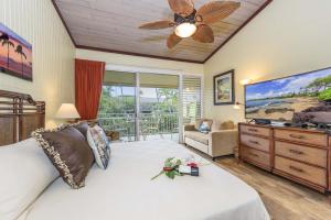 a bedroom with a large bed and a ceiling fan at Napili Shores D229 condo in Kahana