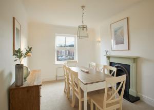 a dining room with a table and chairs and a fireplace at Host & Stay - Osborne House in Whitby