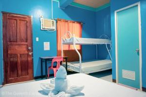 a hospital room with a bed and a table and a bunk bed at King Michael Coron in Coron