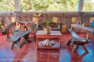a patio with two chairs and a table with a pig on it at King Michael Coron in Coron