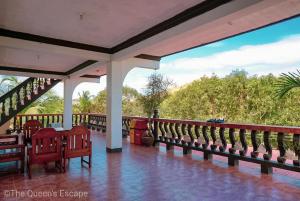 a porch with benches and a view of trees at King Michael Coron in Coron