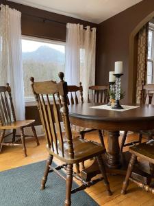a dining room with a table and chairs and a window at Grafton Lodge in Lake Lure