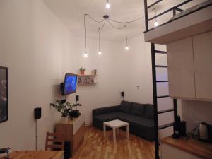 a living room with a couch and a table at Apartment Lenartowicza in Krakow