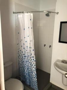 a bathroom with a toilet and a shower curtain at PARADISE EN VICHAYITO II in Vichayito