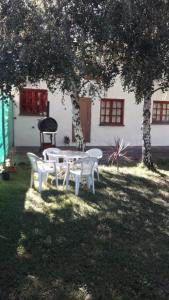 a table and chairs under a tree in a yard at Casa Sur in El Bolsón