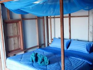 a bed in a room with a blue canopy at Blue Sky Bungalow in Ko Jum