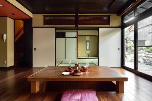 a room with a wooden table in a house at Campton Nishijin Vacation Rental in Kyoto