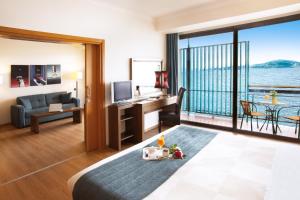 a living room with a view of the ocean at Domotel Xenia Volos in Volos