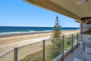 a balcony with a view of the beach at Dorchester On The Beach in Gold Coast
