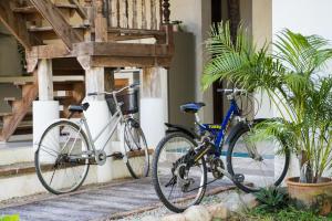 two bikes are parked next to a building at baanchandra in Chiang Mai