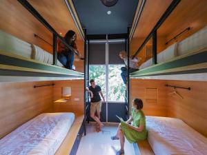 a group of people in a bunk bed house at The Bed KLCC in Kuala Lumpur