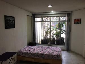 Un pat sau paturi într-o cameră la Terraza Tlalpan-Acoxpa